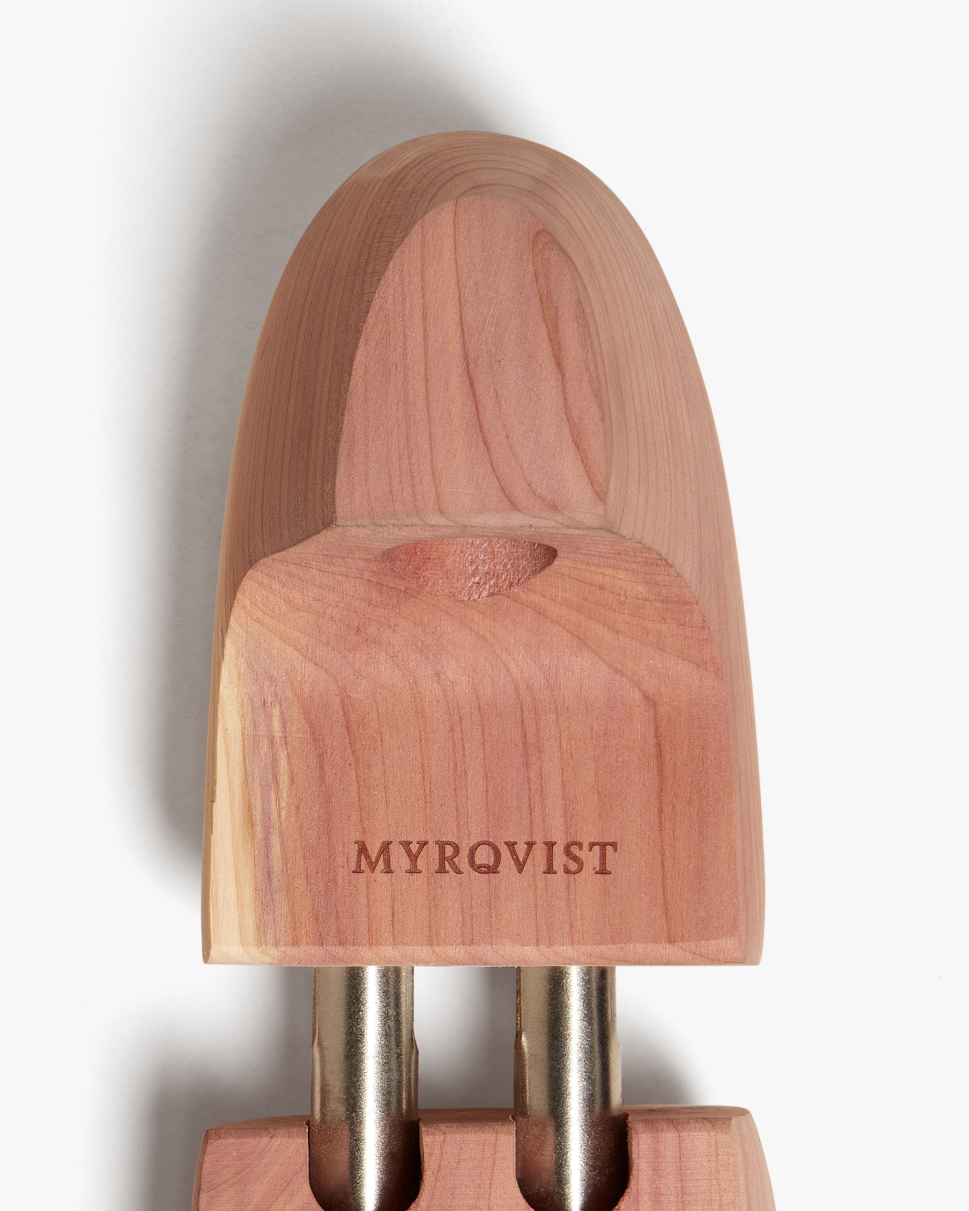 Close-up of the Myrqvist shoe tree in cedar wood, highlighting the engraved branding, smooth finish, and natural wood grain designed to maintain shoe shape and absorb moisture.