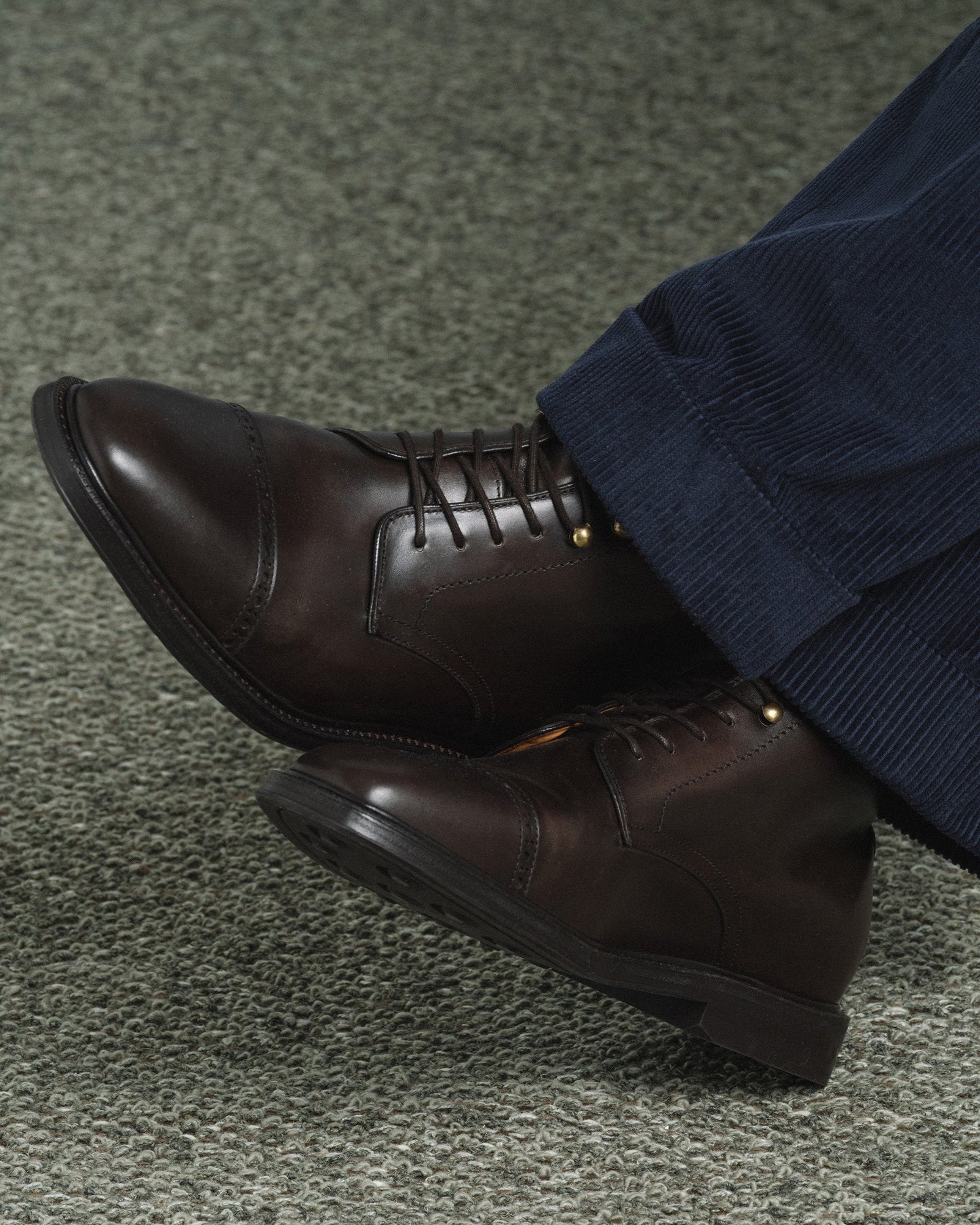 Tjärnö II in dark brown calf worn with navy corduroy trousers, showcasing the boot’s smooth leather, cap toe with subtle broguing, and versatile style for smart casual or business casual looks.